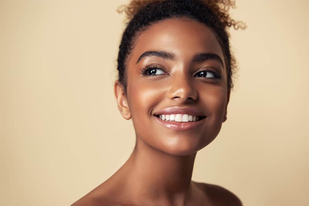 beauty portrait of african american girl beautiful black woman touch her face facial treatment