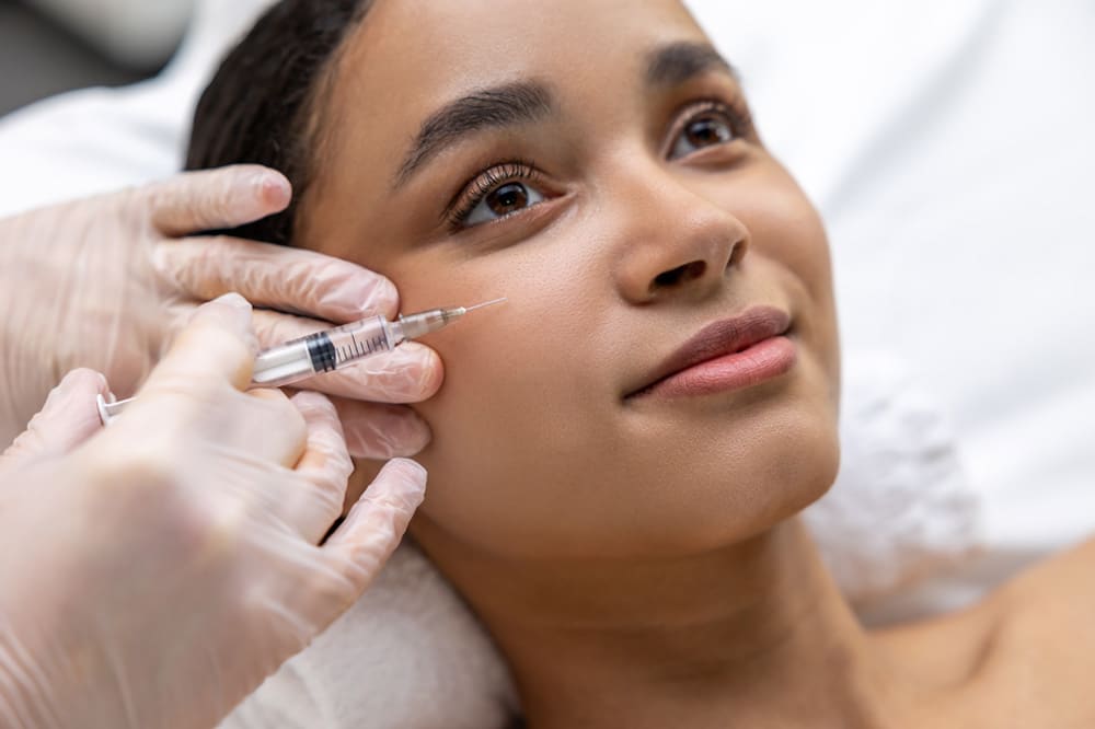 young dark skinned woman having a session of mesotherapy